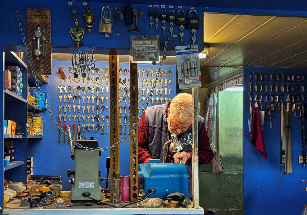 Experienced Solihull locksmith cutting keys in his workshop